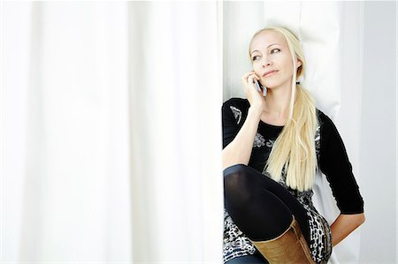 Blond woman using phone, Munich, Bavaria, Germany Stock Photo - Premium Royalty-Free, Code: 6115-07282806