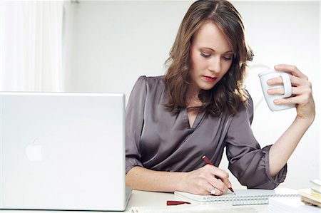 day planner - Woman works at desk, making notes, Munich, Bavaria, Germany Stock Photo - Premium Royalty-Free, Code: 6115-07539591