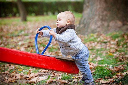 Toddler playing with swing on playground, Osijek, Croatia Stock Photo - Premium Royalty-Free, Code: 6115-07539772