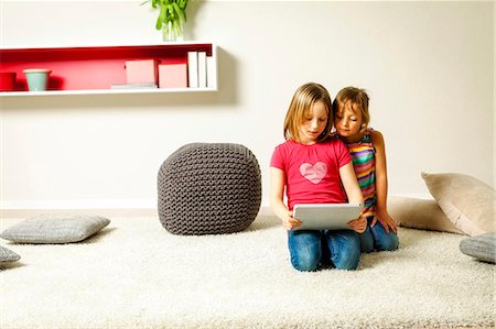 Children using tablet computer at home, Munich, Bavaria, Germany Stock Photo - Premium Royalty-Free, Code: 6115-08066348