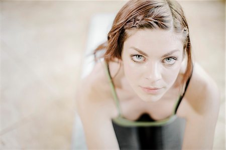 Portrait of young woman doing yoga exercise Stock Photo - Premium Royalty-Free, Code: 6115-08066481
