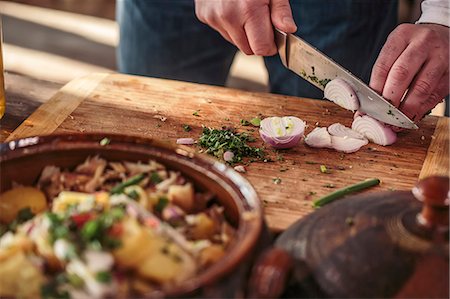 potato salad - Unrecognizable person cutting onions Stock Photo - Premium Royalty-Free, Code: 6115-08066621