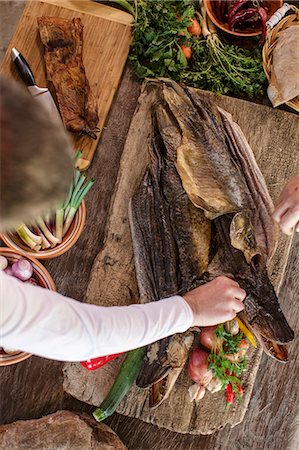 preparing vegetables - Person preparing pike on cutting board Stock Photo - Premium Royalty-Free, Code: 6115-08066627