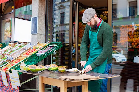 Grocer in front of greengrocer's shop Stock Photo - Premium Royalty-Free, Code: 6115-08149277