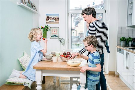 Father and children in kitchen preparing food Stock Photo - Premium Royalty-Free, Code: 6115-08149207