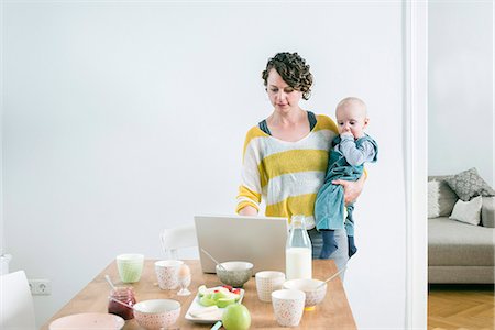 Mother with laptop and children in kitchen Photographie de stock - Premium Libres de Droits, Code: 6115-08149218