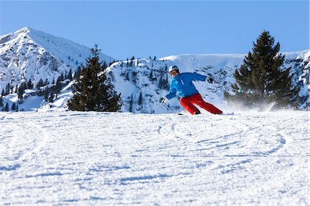 skiing in bavaria - Ski holiday, Skier carving downhill, Sudelfeld, Bavaria, Germany Stock Photo - Premium Royalty-Free, Code: 6115-08149371