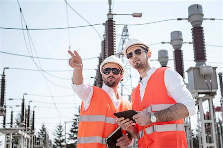 electric mobility - Engineers checking electricity substation Stock Photo - Premium Royalty-Free, Code: 6115-08149383