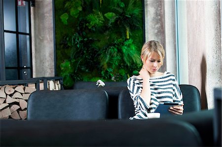 simsearch:6115-08100583,k - Mid adult woman using digital tablet in a cafe Stock Photo - Premium Royalty-Free, Code: 6115-08100510