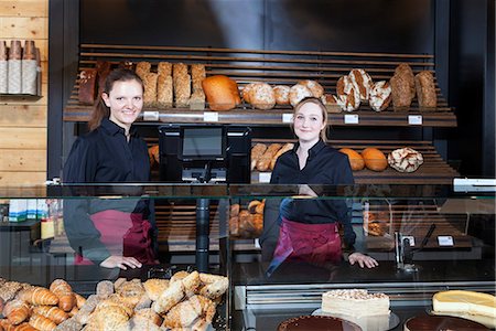 Two female shop assistants at display cabinet in bakery Stock Photo - Premium Royalty-Free, Code: 6115-08100515