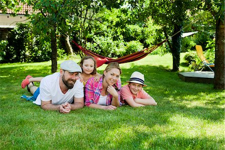 Family with two children relaxing in the garden, Munich, Bavaria, Germany Stock Photo - Premium Royalty-Free, Code: 6115-08100601