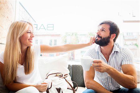 simsearch:6115-07109844,k - Young couple in cafe fooling around Stock Photo - Premium Royalty-Free, Code: 6115-08100777