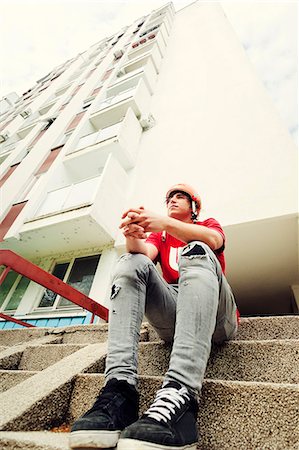 simsearch:6115-08239929,k - BMX biker resting on stairs with folded hands Stock Photo - Premium Royalty-Free, Code: 6115-08100889