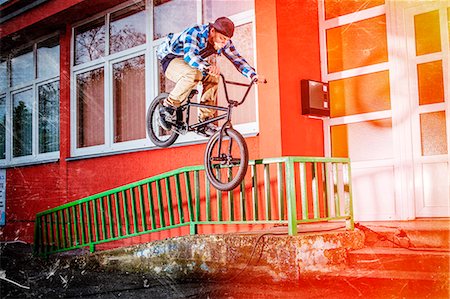 BMX biker jumping over a railing Stock Photo - Premium Royalty-Free, Code: 6115-08100893