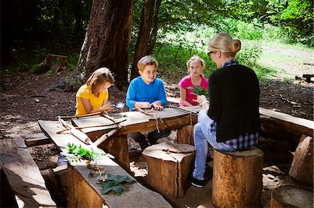 education camp - Children and teacher crafting in forest camp, Munich, Bavaria, Germany Stock Photo - Premium Royalty-Free, Code: 6115-08100807