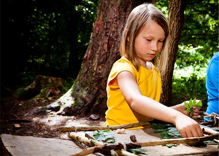 education camp - Schoolgirl crafting in a forest camp, Munich, Bavaria, Germany Stock Photo - Premium Royalty-Free, Code: 6115-08100814