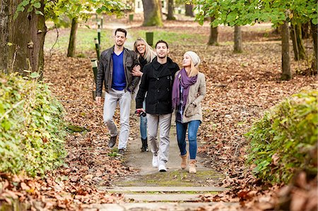 Group of friends walking through autumn park Stock Photo - Premium Royalty-Free, Code: 6115-08100968