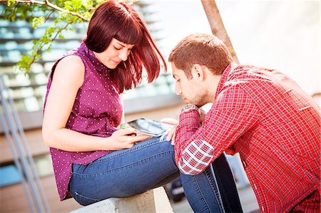 simsearch:6115-08239586,k - Young couple using digital tablet outdoors, Osijek, Croatia Stock Photo - Premium Royalty-Free, Code: 6115-08100991