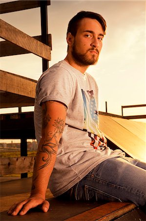 portrait tattoos for men - BMX biker on sports ramp takes a break, looking at camera Foto de stock - Sin royalties Premium, Código: 6115-08100907