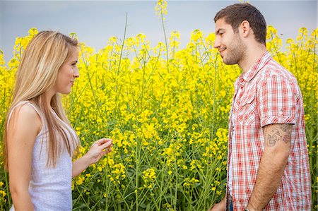 simsearch:6115-08101193,k - Young couple falling in love in colza field, Tuscany, Italy Stock Photo - Premium Royalty-Free, Code: 6115-08101057