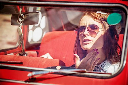 simsearch:6115-08101096,k - Portrait of young woman with sunglasses in red car Stock Photo - Premium Royalty-Free, Code: 6115-08101079