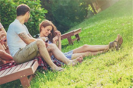 simsearch:6115-08101193,k - Happy young couple relaxing in the meadow Stock Photo - Premium Royalty-Free, Code: 6115-08101094