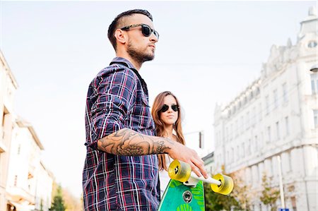 simsearch:6115-08101193,k - Young couple with skateboard outdoors Stock Photo - Premium Royalty-Free, Code: 6115-08101006