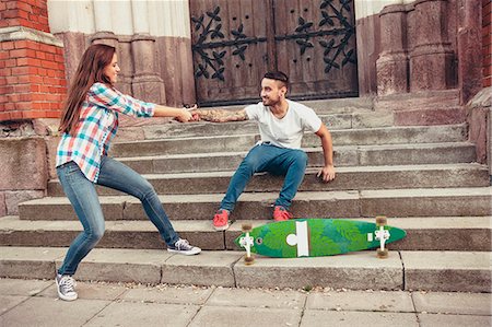 simsearch:6115-08101013,k - Young couple with skateboard fooling around on steps Fotografie stock - Premium Royalty-Free, Codice: 6115-08101030