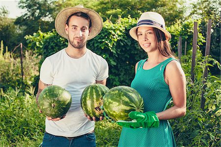 red watermelon - Young couple harvesting watermelons Stock Photo - Premium Royalty-Free, Code: 6115-08101188