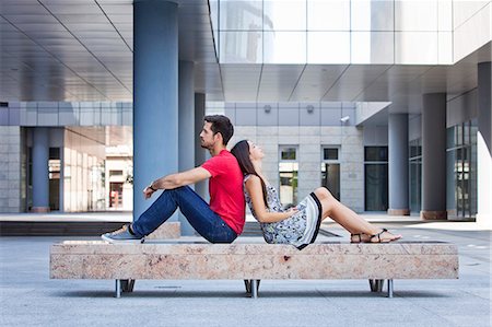 simsearch:6115-08239576,k - Female student leaning against her boyfriends back Stock Photo - Premium Royalty-Free, Code: 6115-08101124