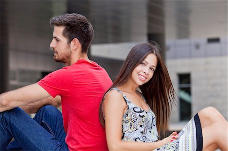 simsearch:6115-08100777,k - Happy young couple sits back to back on campus Photographie de stock - Premium Libres de Droits, Code: 6115-08101126