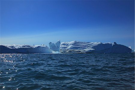 simsearch:6115-08101287,k - Icebergs against blue sky, Arctic Ocean, Greenland Stock Photo - Premium Royalty-Free, Code: 6115-08101256