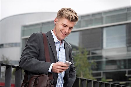 portrait outside work - Young businessman using smart phone, Munich, Bavaria, Germany Stock Photo - Premium Royalty-Free, Code: 6115-08101371