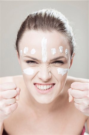 simsearch:6115-08105067,k - Young woman with streaks of lotion on face Foto de stock - Sin royalties Premium, Código: 6115-08105063