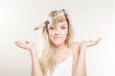 simsearch:6115-08105095,k - Young woman with hairbrush fooling around Stock Photo - Premium Royalty-Free, Code: 6115-08105116