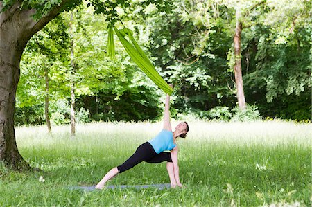 rubber bands - Young woman does stretching exercises with rubber band, Munich, Bavaria, Germany Stock Photo - Premium Royalty-Free, Code: 6115-08105136