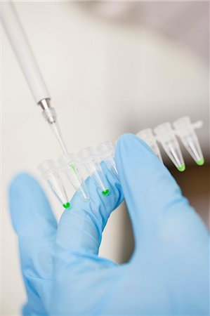Scientist pipetting samples for testing Stock Photo - Premium Royalty-Free, Code: 6115-08105232