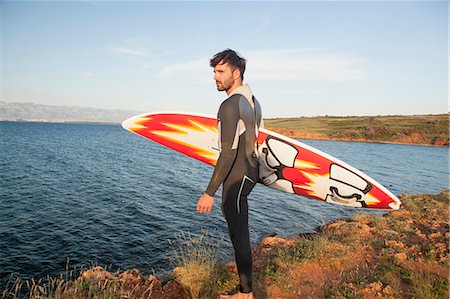 simsearch:6115-08239310,k - Surfer with surfboard on beach Foto de stock - Sin royalties Premium, Código: 6115-08239347