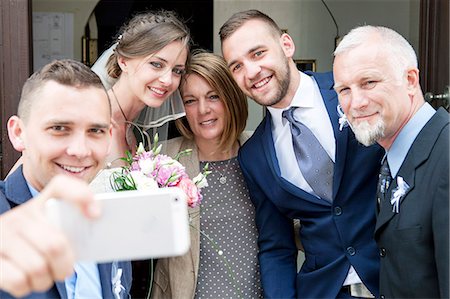 simsearch:6115-08239504,k - Groom, bride and family taking photo of themselves Stock Photo - Premium Royalty-Free, Code: 6115-08239392