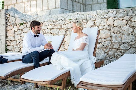 simsearch:6115-08239477,k - Bridegroom and bride drinking champagne outdoors Stock Photo - Premium Royalty-Free, Code: 6115-08239473