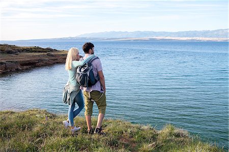 simsearch:6115-08239578,k - Young couple on cliff looking at sea Stock Photo - Premium Royalty-Free, Code: 6115-08239597
