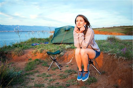 simsearch:6115-08239576,k - Young woman at campsite day dreaming Stock Photo - Premium Royalty-Free, Code: 6115-08239646