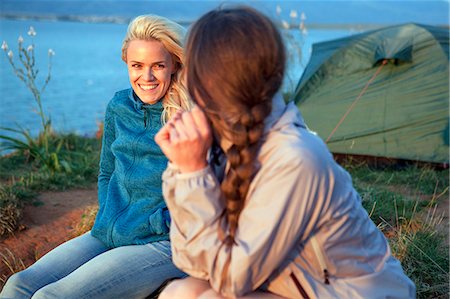 Two women at campsite talking Stock Photo - Premium Royalty-Free, Code: 6115-08239649