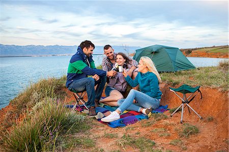 Group of friends at campsite celebrating Stock Photo - Premium Royalty-Free, Code: 6115-08239655