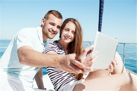 simsearch:6115-08239578,k - Young couple using digital tablet on sailboat, Adriatic Sea Stock Photo - Premium Royalty-Free, Code: 6115-08239684