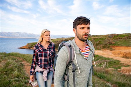 simsearch:6115-08239587,k - Young couple hiking along coastal path Photographie de stock - Premium Libres de Droits, Code: 6115-08239602