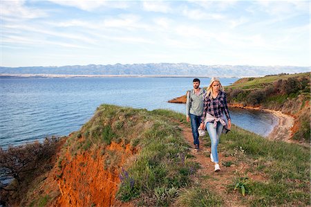 simsearch:6115-08239578,k - Young couple hiking along coastal path Stock Photo - Premium Royalty-Free, Code: 6115-08239607