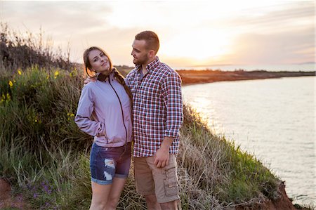 simsearch:6115-08239620,k - Portrait of happy couple on water's edge Foto de stock - Sin royalties Premium, Código: 6115-08239631