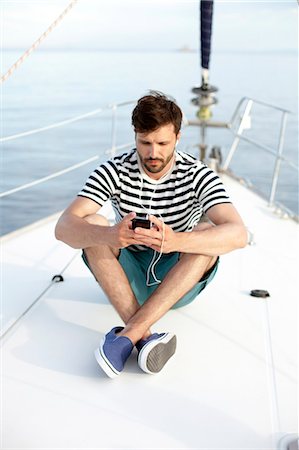 sailing music - Man listening to music on sailboat, Adriatic Sea Stock Photo - Premium Royalty-Free, Code: 6115-08239794