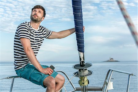 sailing music - Man listening to music on sailboat, Adriatic Sea Stock Photo - Premium Royalty-Free, Code: 6115-08239795